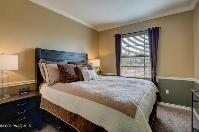 a bed sitting in a bedroom next to a window