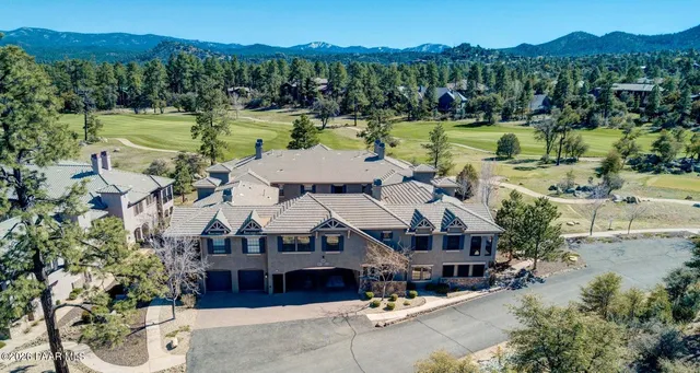 a aerial view of a house with swimming pool and a yard