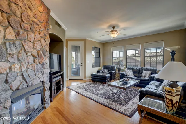 a living room with fireplace furniture and a rug