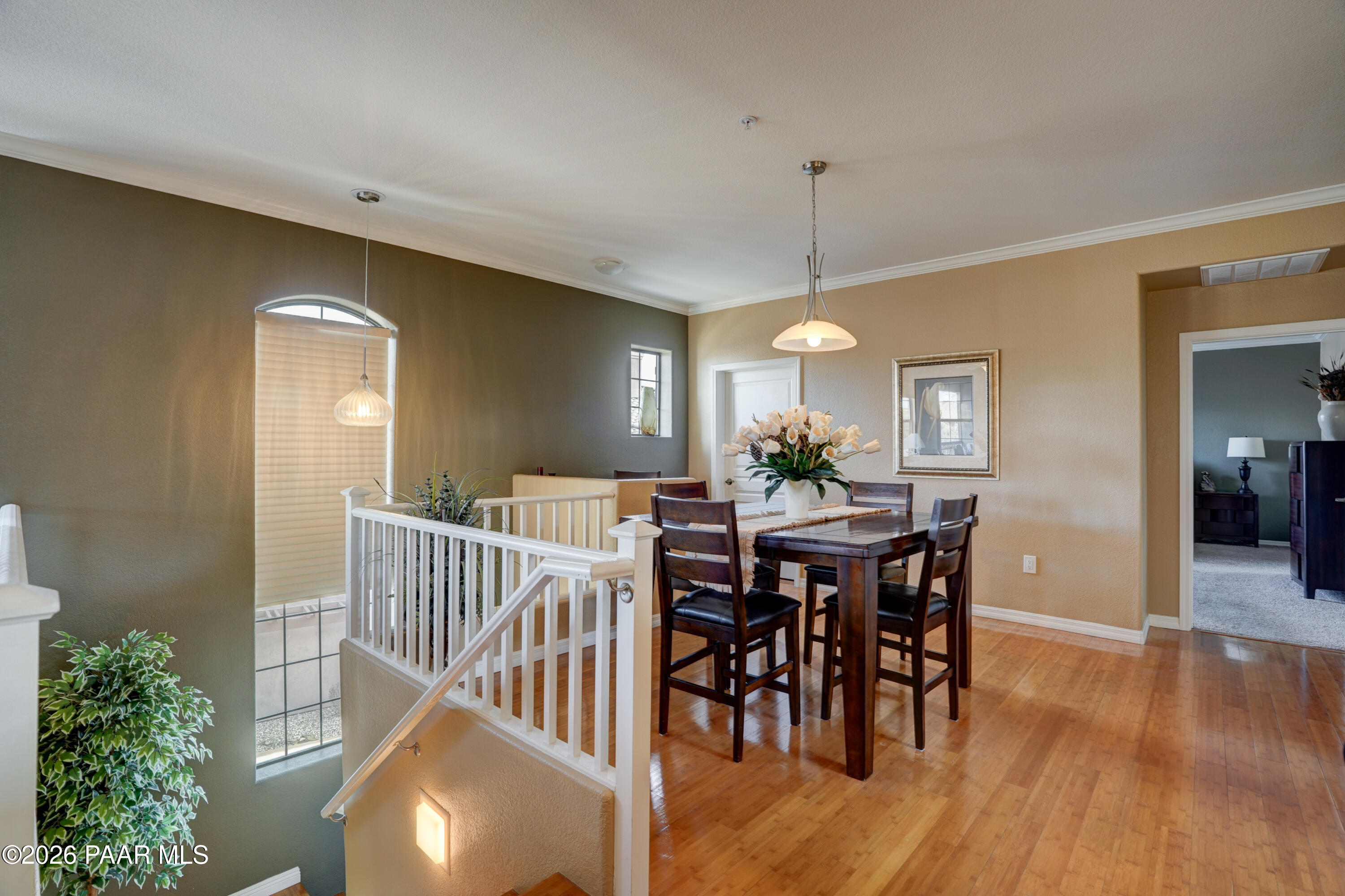 1716 Alpine Meadows Lane, Unit 405 Prescott, AZ 86303 - Photo 9 of 29 a view of a a dining room with furniture window and wooden floor