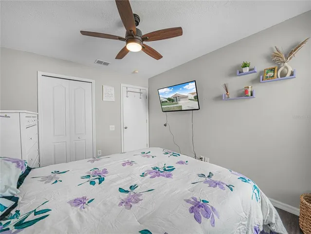 a bedroom with a bed and a chandelier