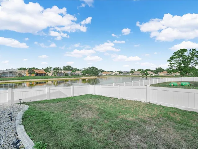 a view of a lake with houses in the back