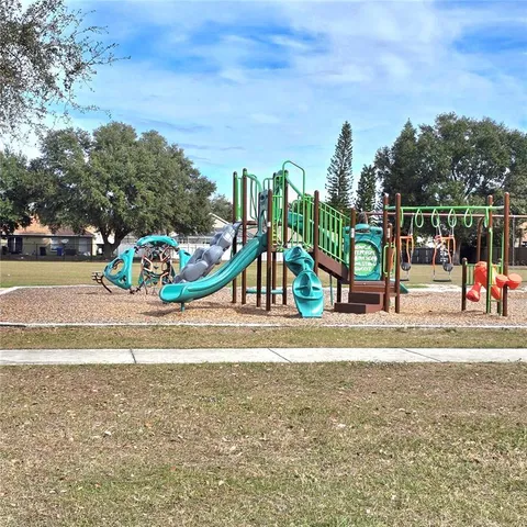 a view of a park with swings and slides