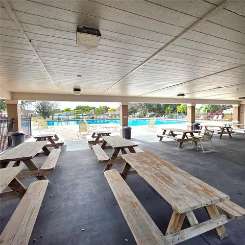 a view of a patio with lawn chairs