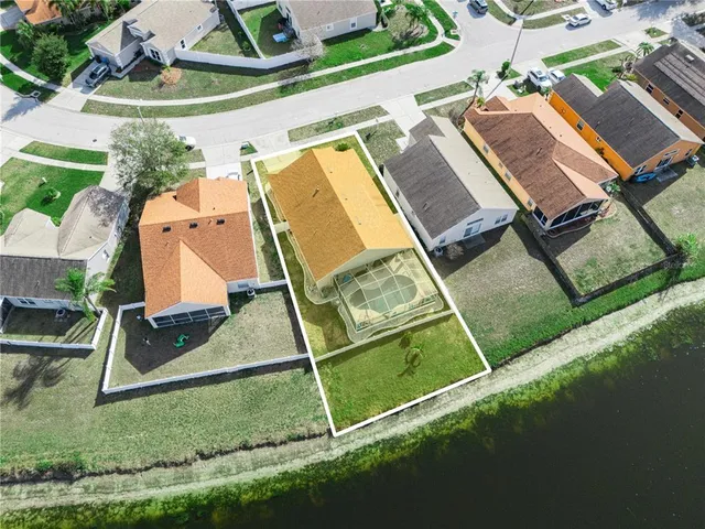 a room with stainless steel appliances kitchen island granite countertop furniture and a wooden floor