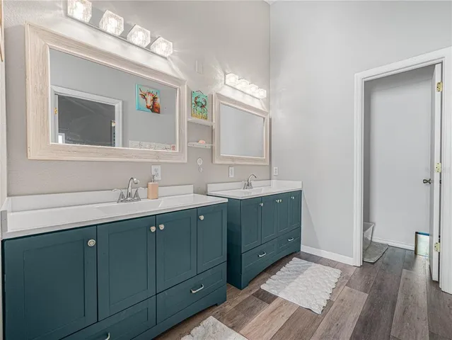 a bathroom with a double vanity sink and a mirror