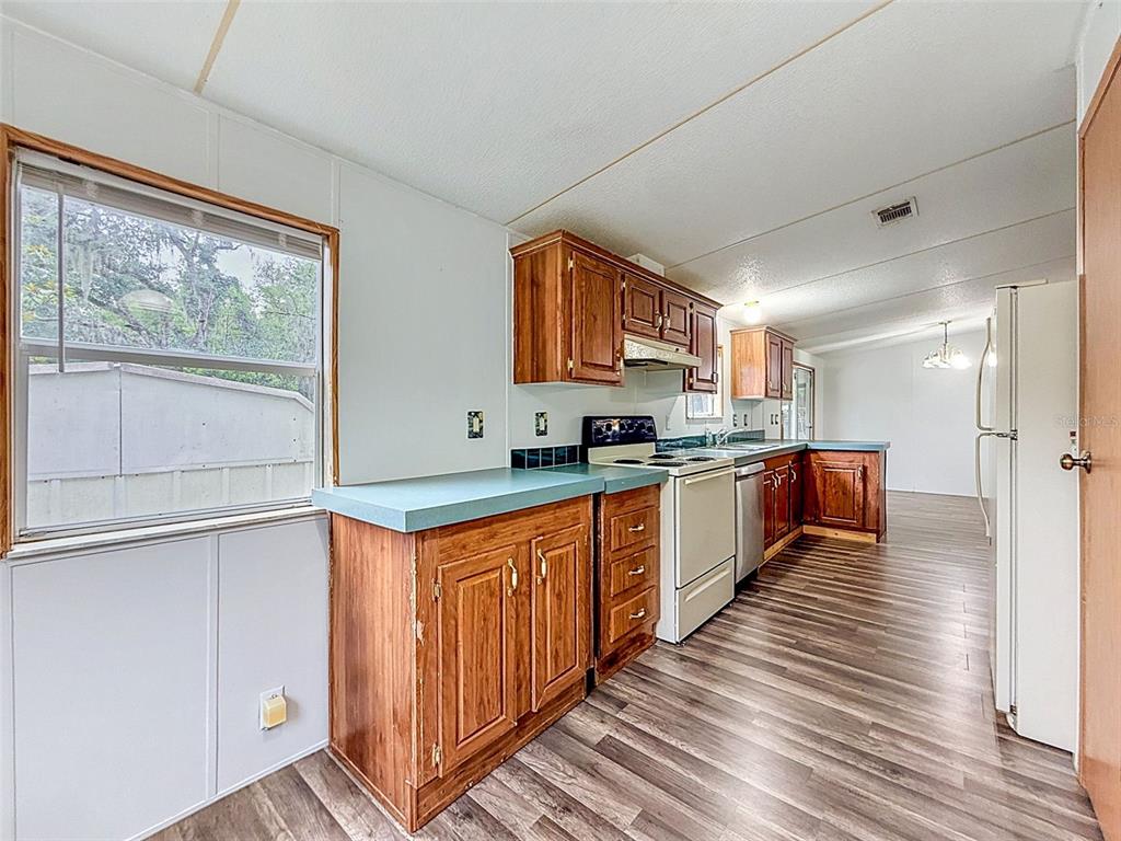 1819 Sinclair Hills Road Lutz, FL 33549 - Photo 50 of 60 a kitchen with stainless steel appliances granite countertop a stove a sink and a refrigerator