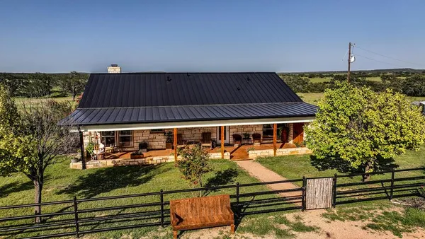 an aerial view of a house with swimming pool garden and patio