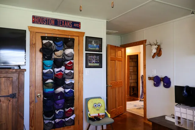 a roof deck with table and chairs potted plants with wooden floor and fence