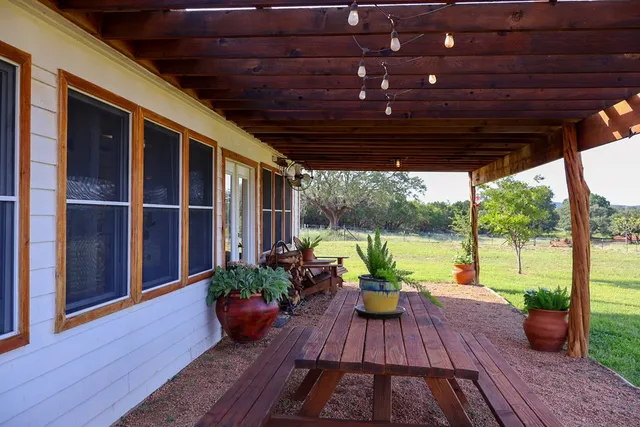 a building outdoor space with patio furniture and potted plants