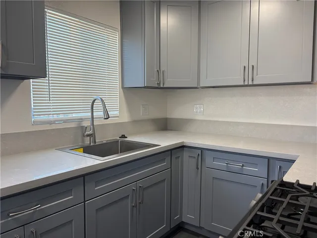 a kitchen with a sink cabinets and window