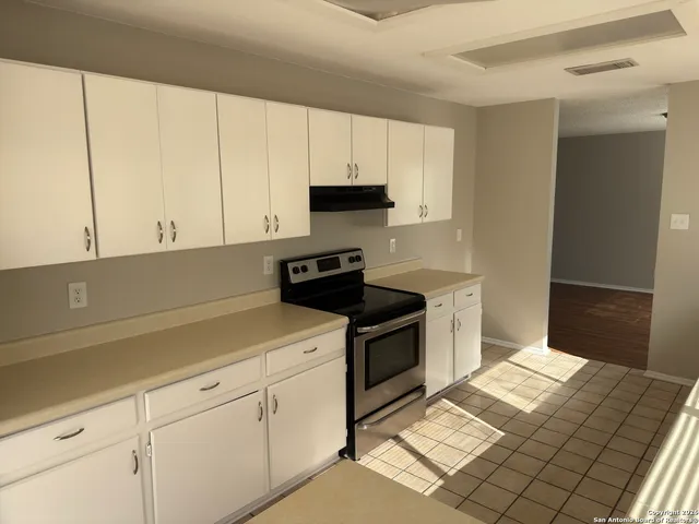 a kitchen with cabinets and appliances