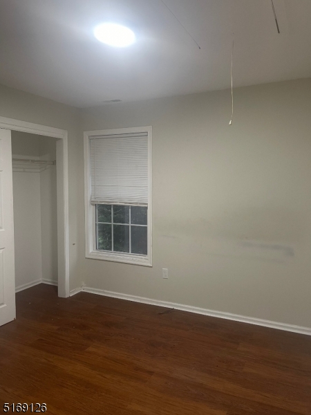 406 South 7th Street, Unit 2 Newark, NJ 07103 - Photo 7 of 9 a view of an empty room with wooden floor and a window