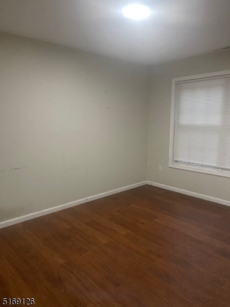 406 South 7th Street, Unit 2 Newark, NJ 07103 - Photo 8 of 9 an empty room with wooden floor and windows
