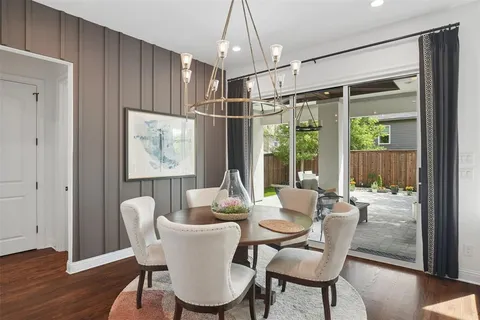 a dining room with furniture a chandelier and wooden floor