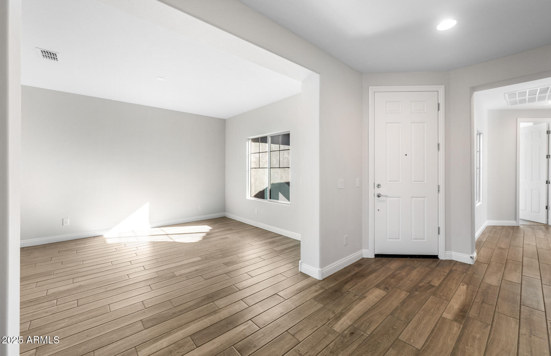 6808 West Ripken Way Florence, AZ 85132 - Photo 15 of 38 a view of empty room with wooden floor
