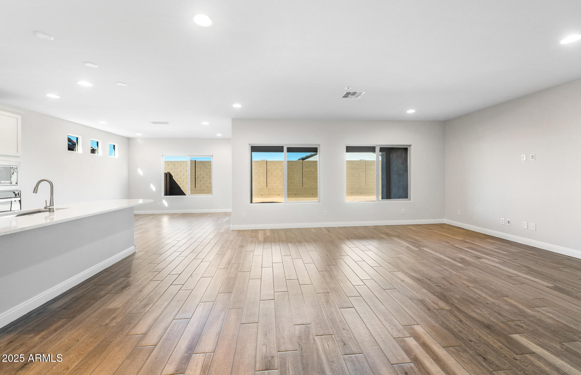 6808 West Ripken Way Florence, AZ 85132 - Photo 17 of 38 a view of an empty room with wooden floor and a window