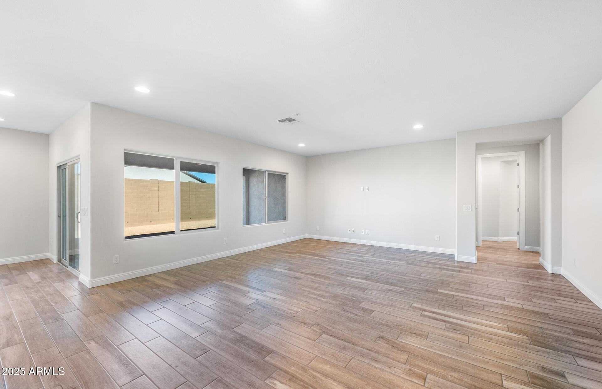 6808 West Ripken Way Florence, AZ 85132 - Photo 18 of 38 a view of an empty room with wooden floor and a window