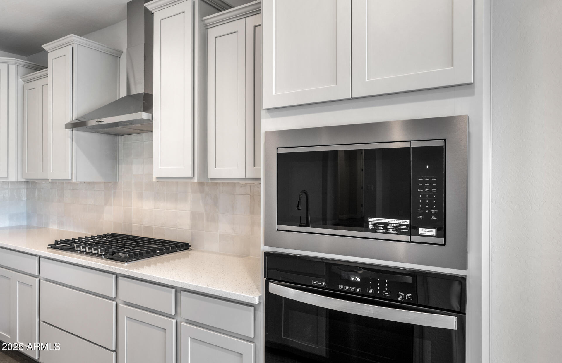 6808 West Ripken Way Florence, AZ 85132 - Photo 24 of 38 a kitchen with white cabinets and appliances