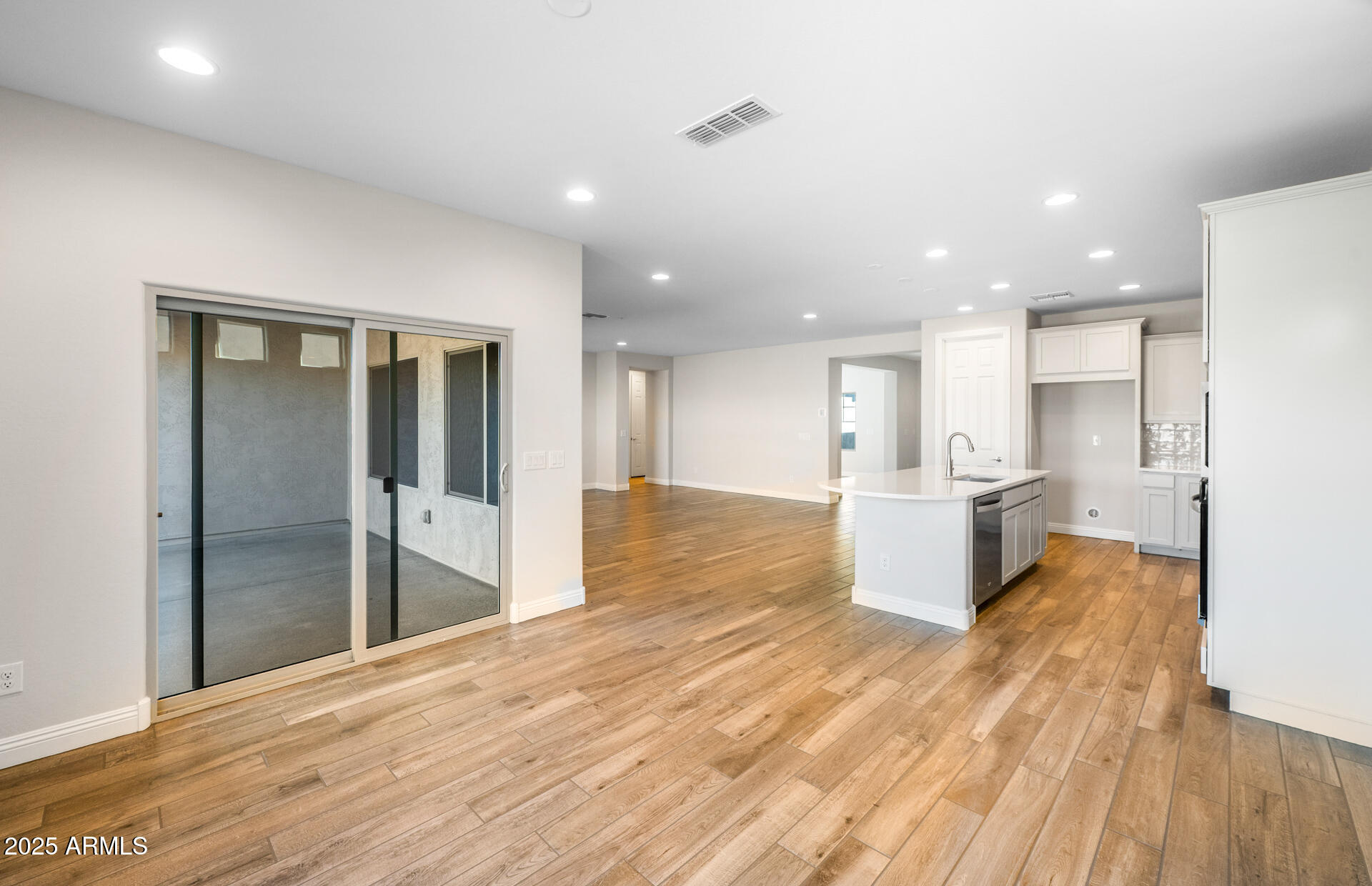 6808 West Ripken Way Florence, AZ 85132 - Photo 28 of 38 a view of kitchen with kitchen island wooden floor center island and stainless steel appliances