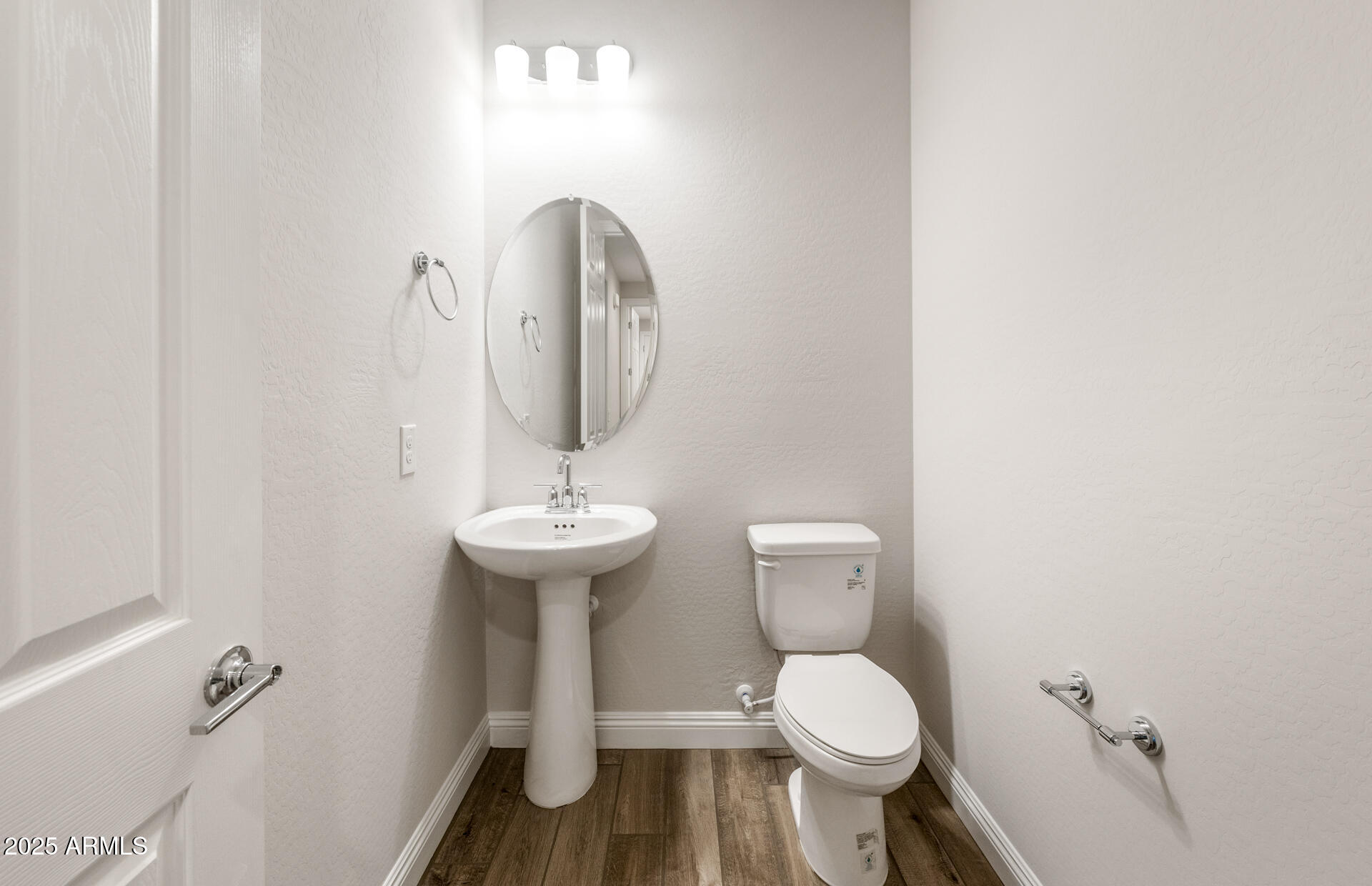 6808 West Ripken Way Florence, AZ 85132 - Photo 30 of 38 a bathroom with a toilet sink and mirror
