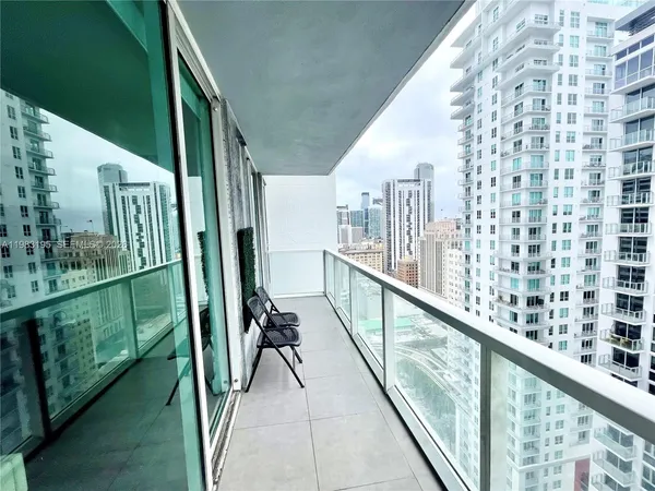 a view of a living room and balcony