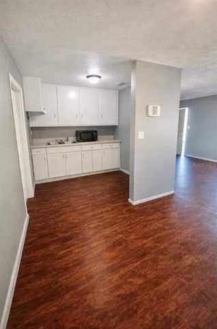 a view of kitchen with wooden floor