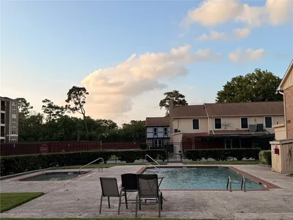 a view of a swimming pool with a lounge chairs
