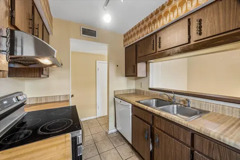 a kitchen with a sink stove and cabinets