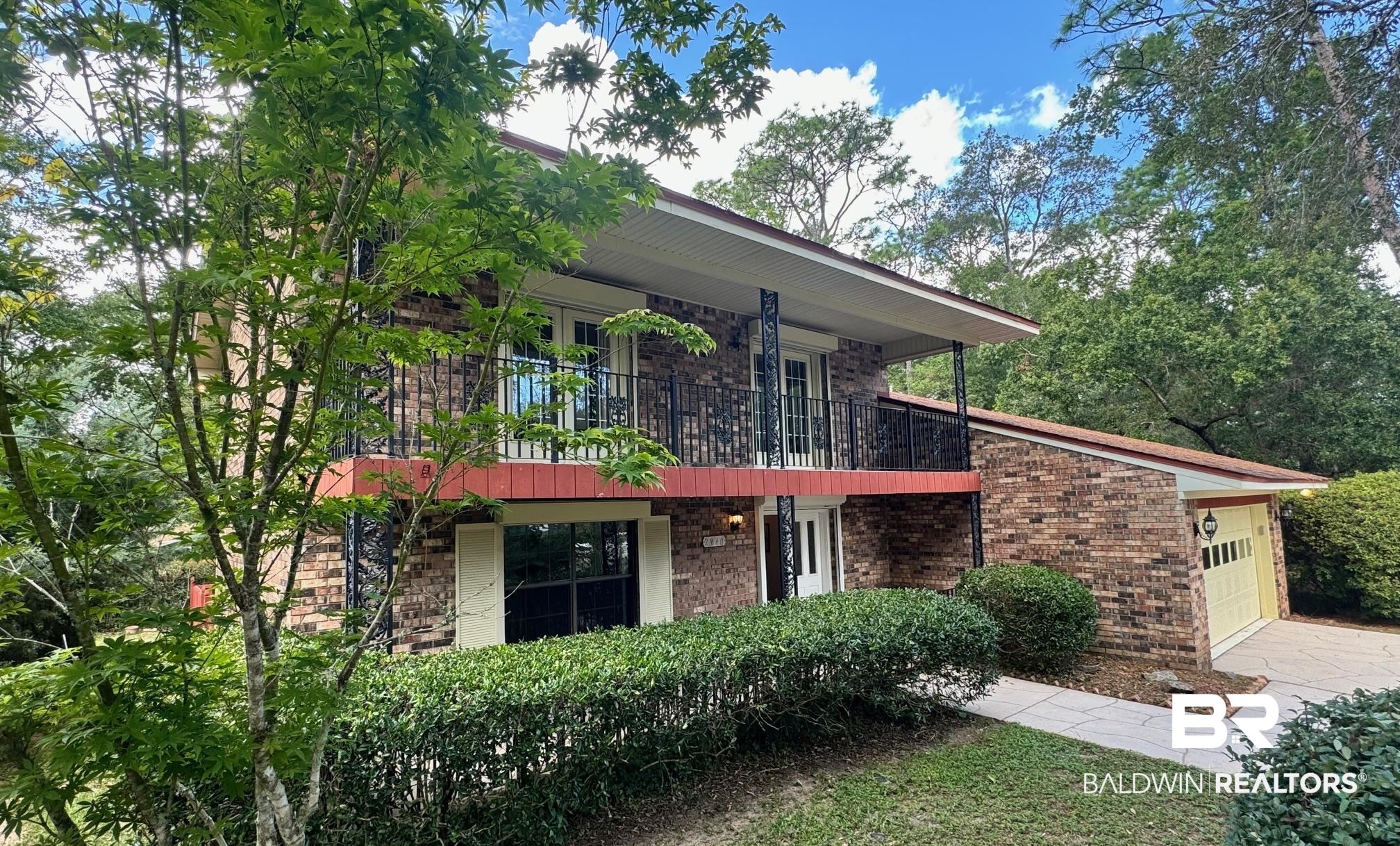 2240 Perdido Circle Lillian, AL 36549 - Photo 1 of 42 View of front facade featuring a balcony and a garage