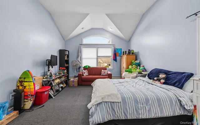 a bedroom with a bed a couch and a window