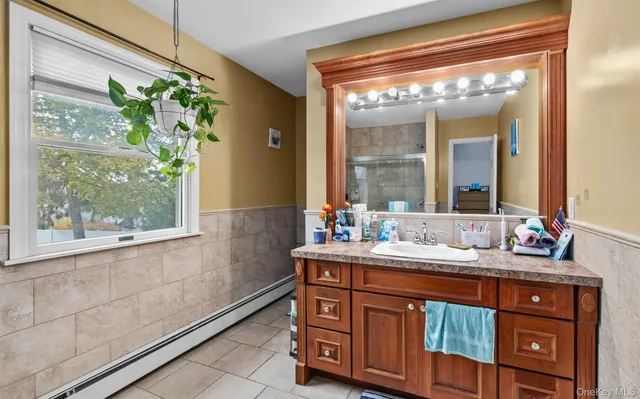 a bathroom with a double vanity sink and a mirror