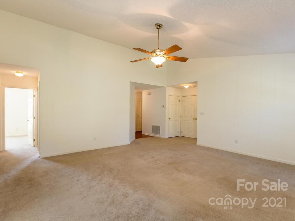 83 Planters Creek Road Fletcher, NC 28732 - Photo 11 of 38 an empty room with a window and a ceiling fan