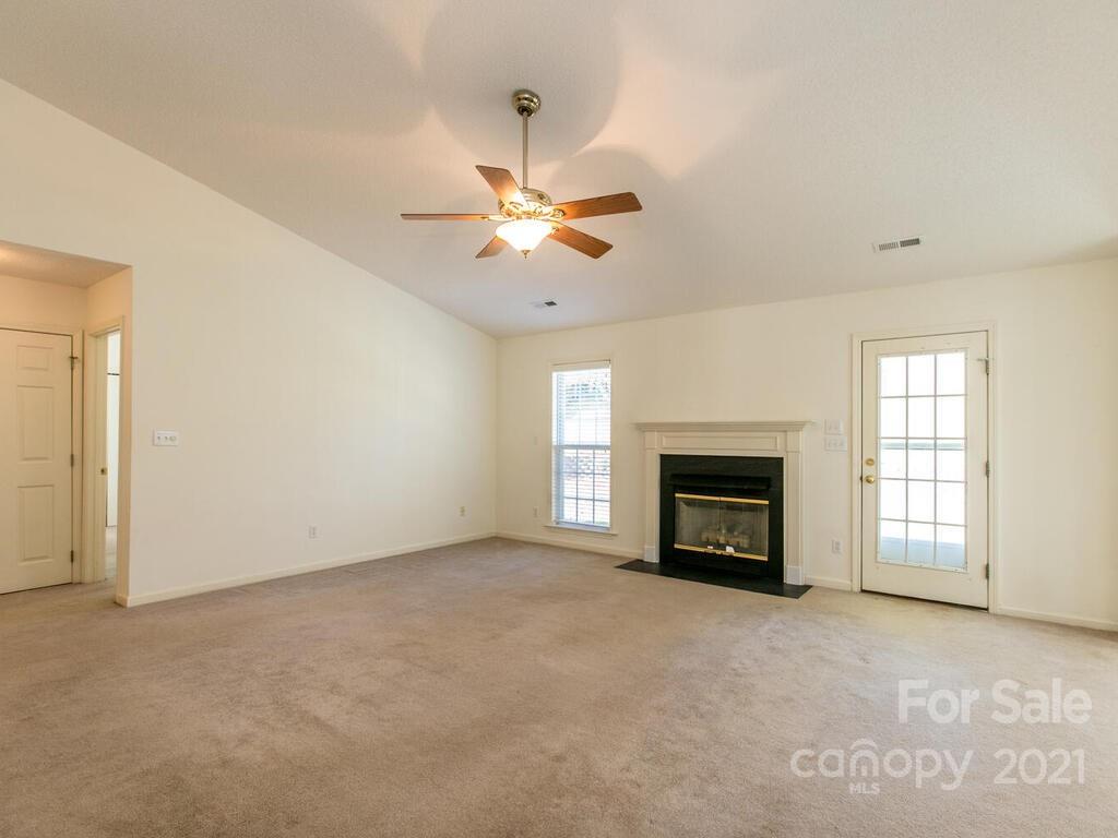83 Planters Creek Road Fletcher, NC 28732 - Photo 12 of 38 an empty room with windows and fireplace