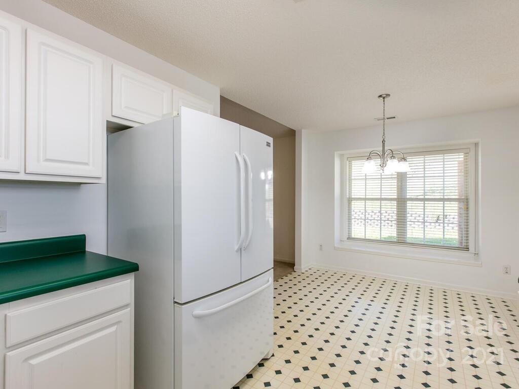 83 Planters Creek Road Fletcher, NC 28732 - Photo 17 of 38 a kitchen with a refrigerator and window