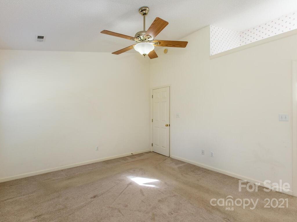 83 Planters Creek Road Fletcher, NC 28732 - Photo 21 of 38 a view of a room with a ceiling fan and a window