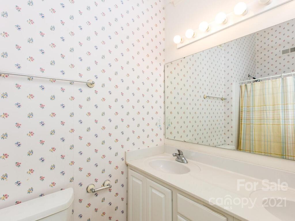 83 Planters Creek Road Fletcher, NC 28732 - Photo 23 of 38 a bathroom with a sink a toilet and shower