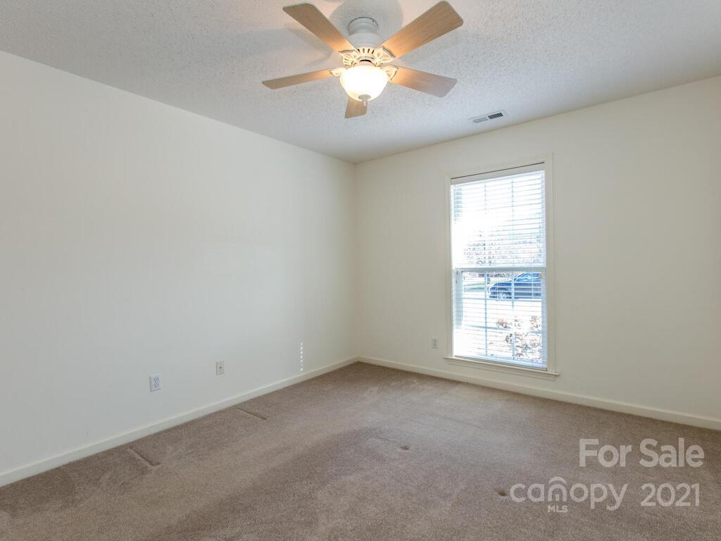 83 Planters Creek Road Fletcher, NC 28732 - Photo 25 of 38 an empty room with a window and a fan
