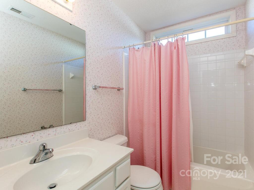 83 Planters Creek Road Fletcher, NC 28732 - Photo 28 of 38 a bathroom with a sink a toilet and shower curtain
