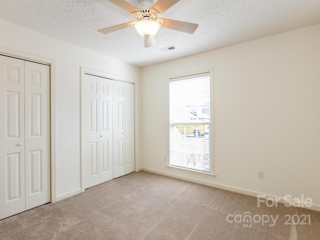 83 Planters Creek Road Fletcher, NC 28732 - Photo 29 of 38 an empty room with windows and fan
