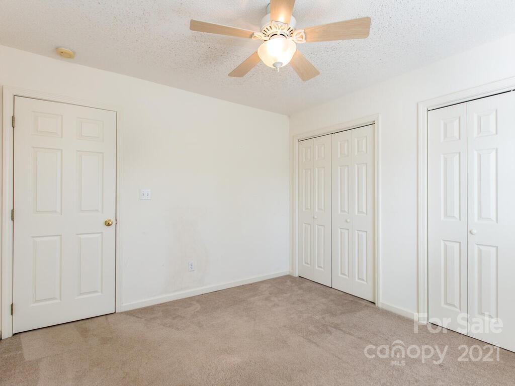 83 Planters Creek Road Fletcher, NC 28732 - Photo 30 of 38 an empty room with a ceiling fan
