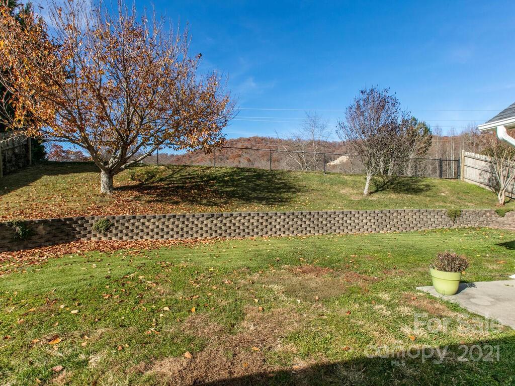 83 Planters Creek Road Fletcher, NC 28732 - Photo 7 of 38 a view of a big yard with wooden fence