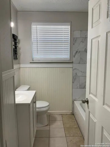 a bathroom with a toilet a sink and bathtub