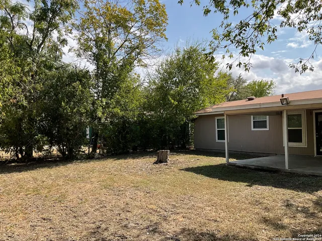 a backyard of a house with lots of green space