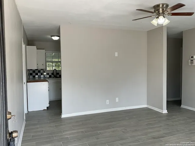 a view of a kitchen with a sink and refrigerator