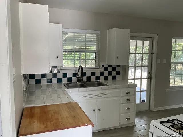 a kitchen with lots of counter space and windows