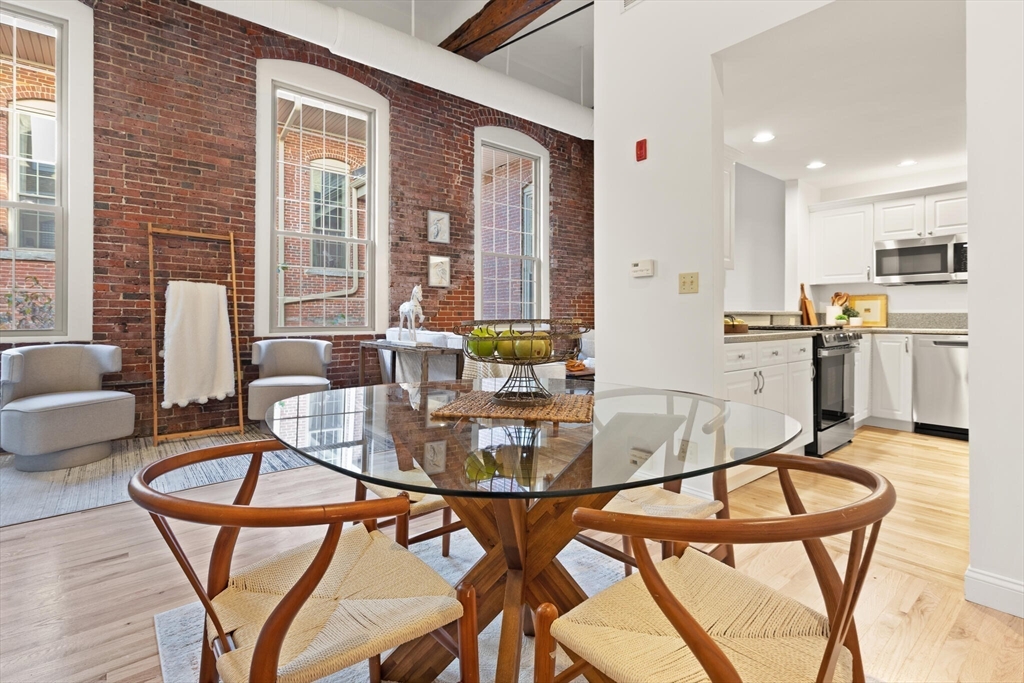 a dining room with furniture and wooden floor