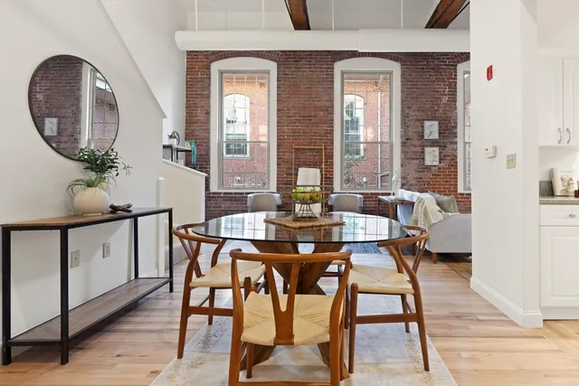 a view of a dining room with furniture and a potted plant