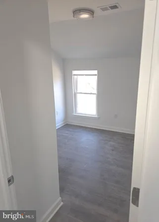 an empty room with wooden floor