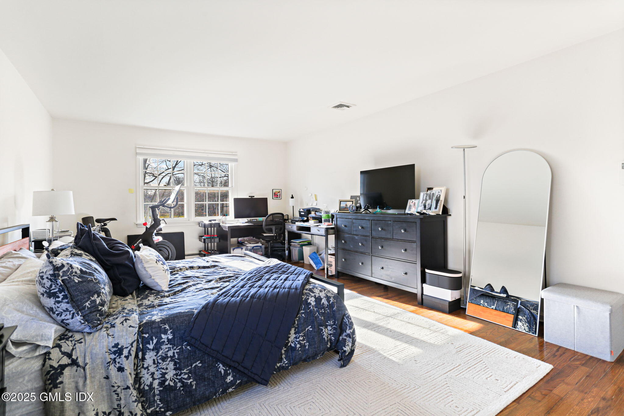 38 A Orchard Street Cos Cob, CT 06807 - Photo 12 of 26 a spacious bedroom with a large bed and a flat screen tv